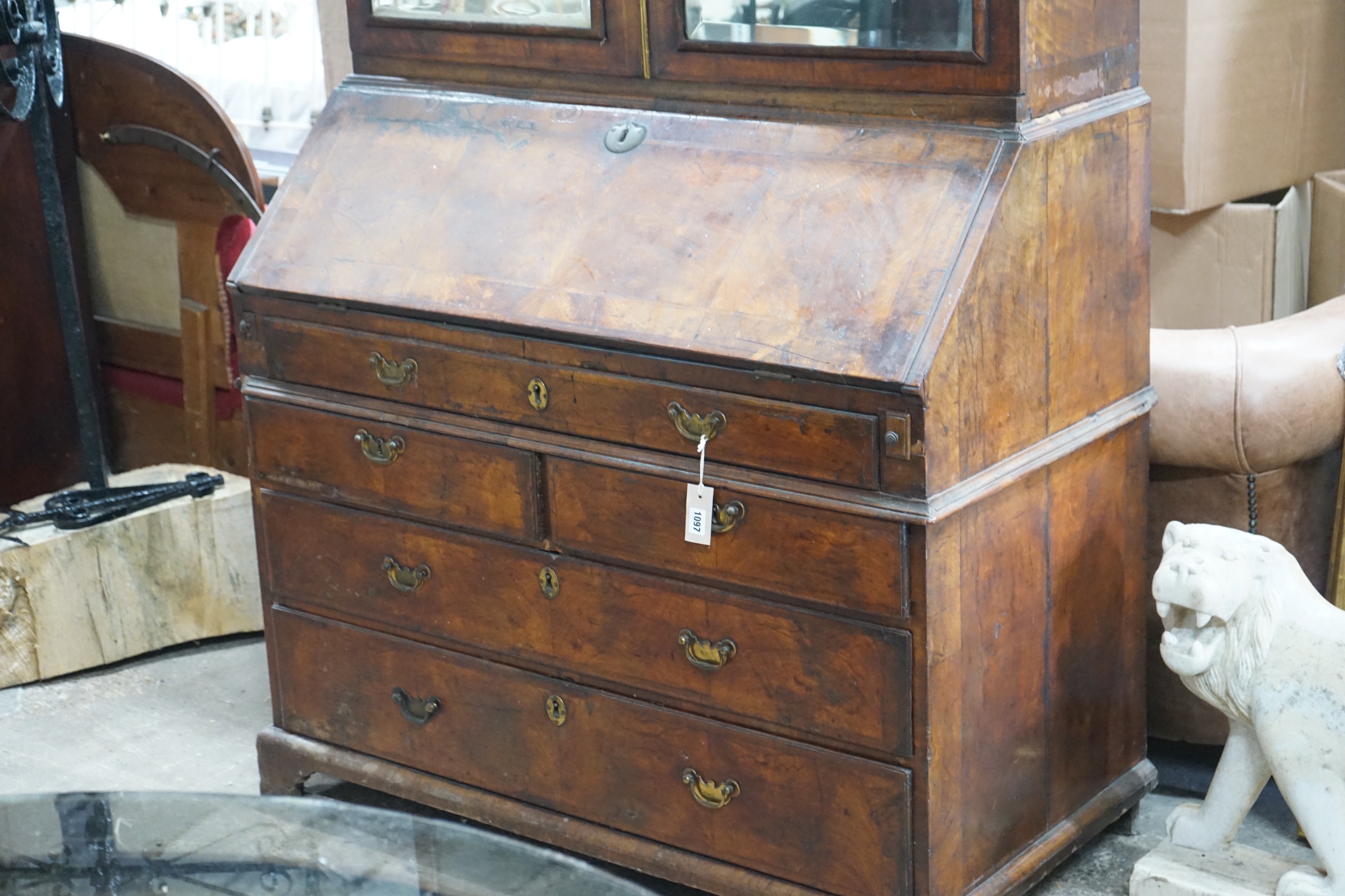 A mid 18th century feather banded figured walnut bureau cabinet, width 111cm, depth 57cm, height 207cm